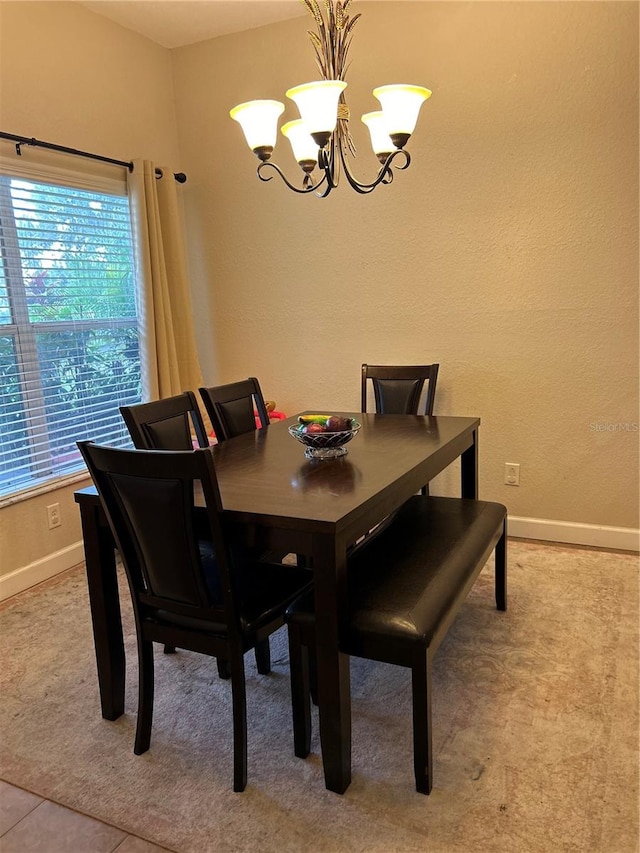 dining area with an inviting chandelier and tile patterned floors