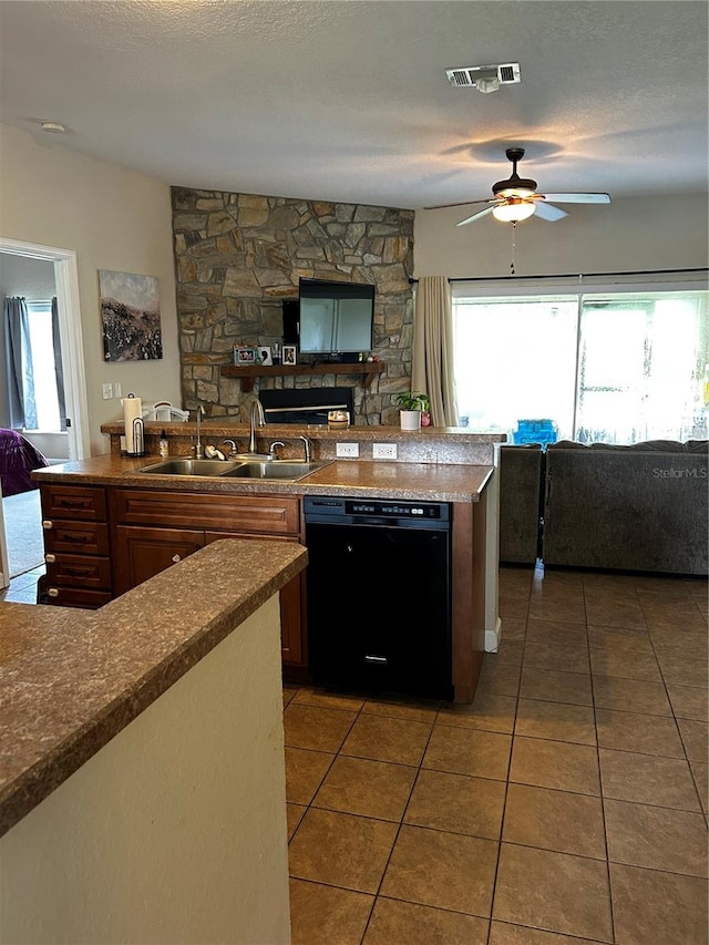 kitchen with a textured ceiling, dishwasher, ceiling fan, and sink