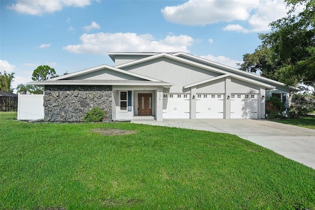 view of front of property with a garage and a front lawn