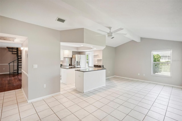 kitchen featuring kitchen peninsula, light tile patterned flooring, stainless steel fridge with ice dispenser, and ceiling fan