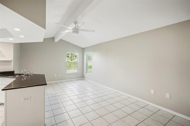 unfurnished living room featuring lofted ceiling with beams, sink, ceiling fan, and light tile patterned floors