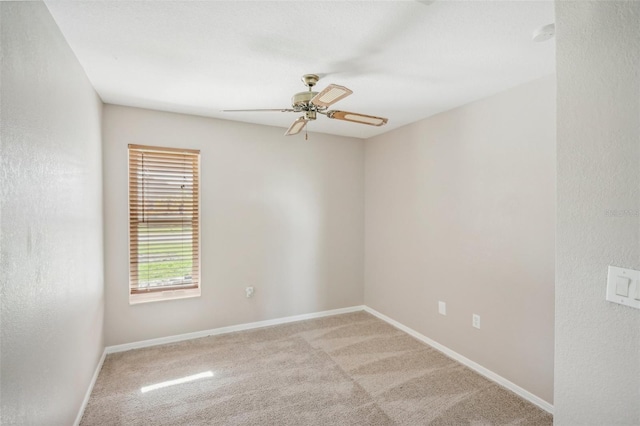 unfurnished room featuring ceiling fan and carpet flooring