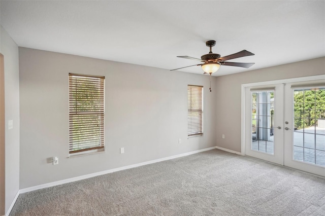 spare room with french doors, carpet floors, and ceiling fan