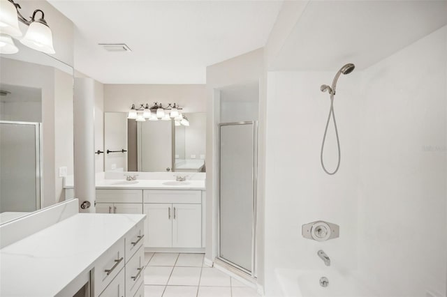 bathroom with tile patterned flooring and dual vanity