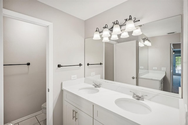 bathroom with tile patterned flooring, dual bowl vanity, and toilet