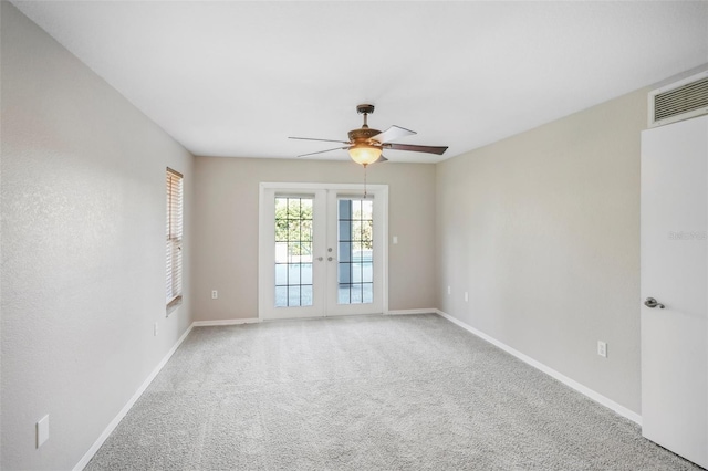 empty room with carpet floors, french doors, and ceiling fan