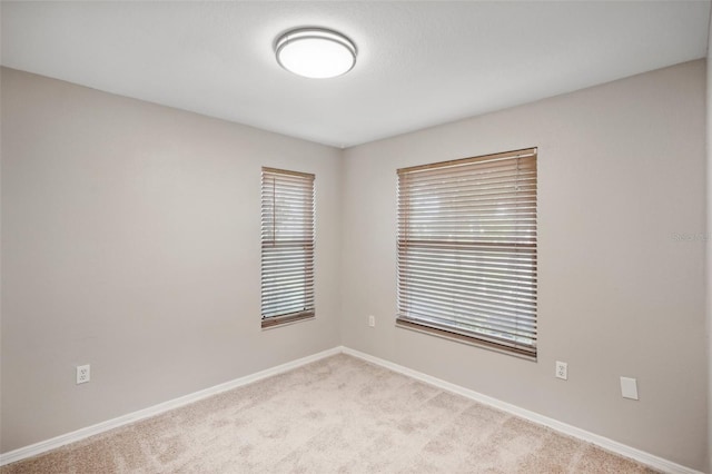 empty room featuring light carpet