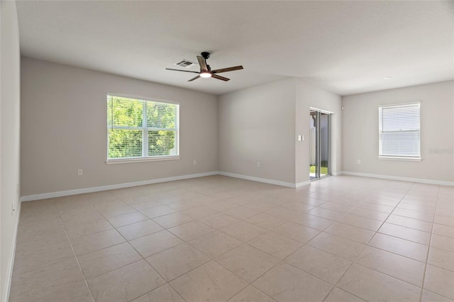 tiled spare room featuring ceiling fan