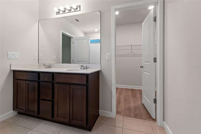 bathroom featuring tile patterned floors and double sink vanity