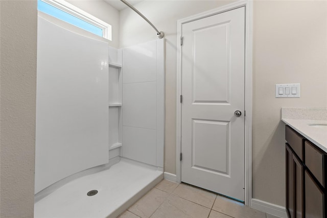 bathroom featuring a shower, vanity, and tile patterned floors