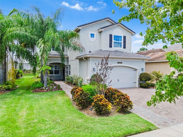 mediterranean / spanish house with a garage and a front yard