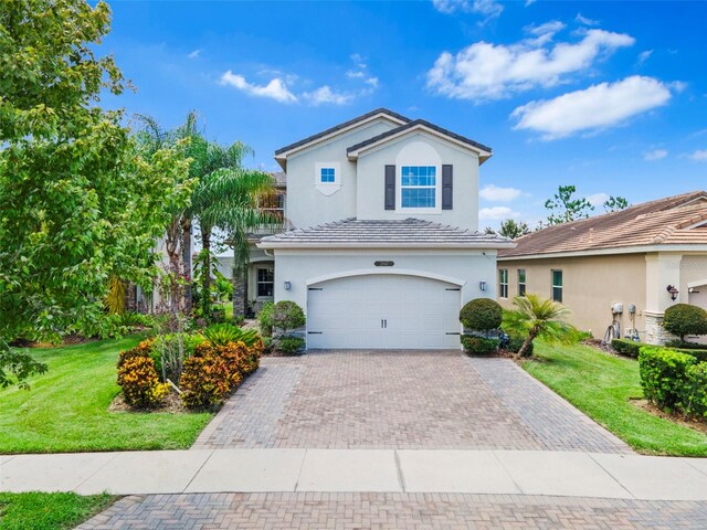 front of property with a garage and a front lawn