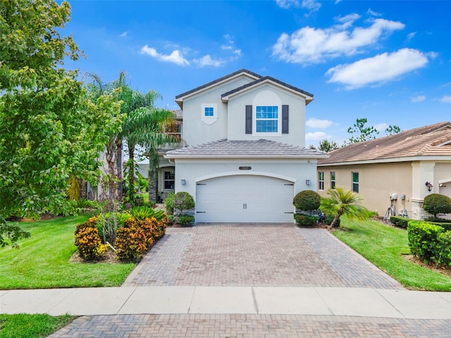 view of property with a garage and a front yard