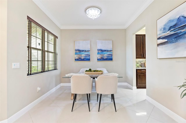 dining area with crown molding and light tile patterned floors