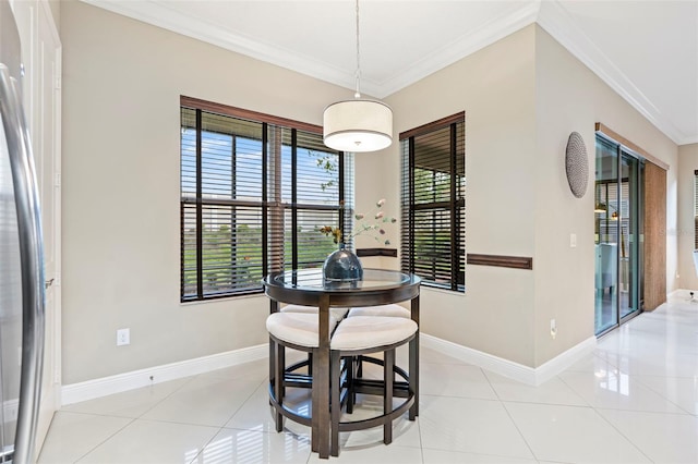 dining room with light tile patterned flooring and ornamental molding