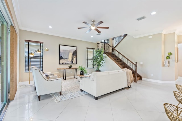 living room with ornamental molding, light tile patterned floors, and ceiling fan