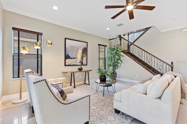 living room featuring crown molding, ceiling fan, and light tile patterned floors