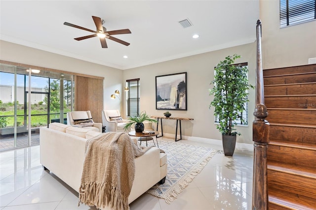 tiled living room with crown molding and ceiling fan