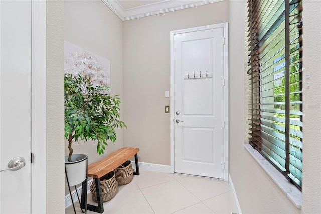 tiled entryway featuring crown molding