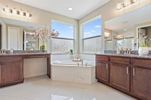 bathroom with vanity, tile patterned flooring, and plus walk in shower