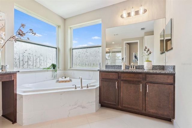 bathroom featuring tile patterned floors, vanity, and plus walk in shower