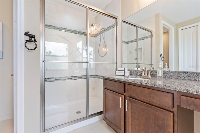 bathroom featuring walk in shower and vanity