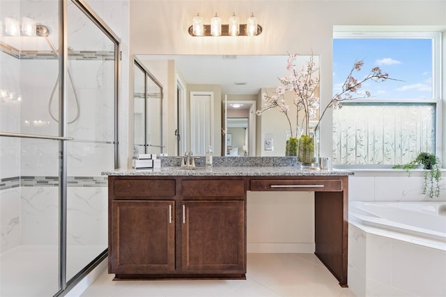 bathroom with vanity, tile patterned flooring, and plus walk in shower