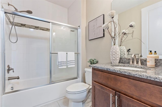 full bathroom with vanity, toilet, tile patterned flooring, and combined bath / shower with glass door