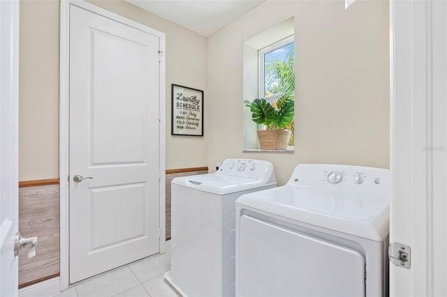 laundry room featuring light tile patterned floors and washer and clothes dryer