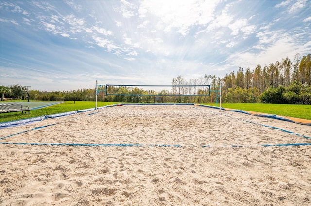 view of community with a yard and volleyball court