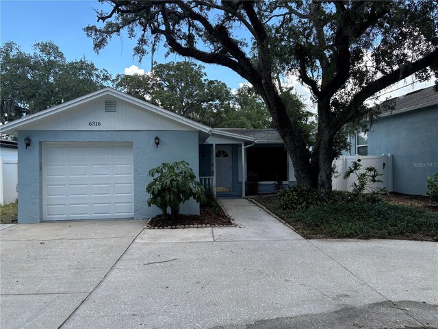 ranch-style home featuring a garage