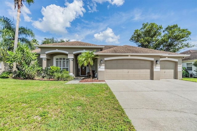 view of front of house with a garage and a front lawn