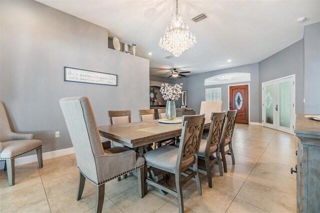 dining area featuring ceiling fan with notable chandelier and light tile patterned floors