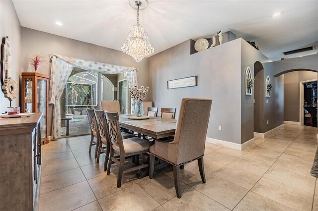 tiled dining space with a notable chandelier