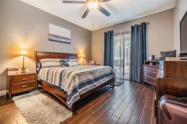 bedroom with dark wood-type flooring, access to outside, and ceiling fan