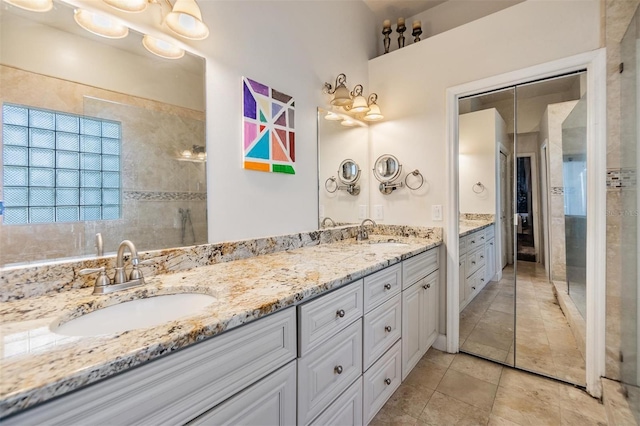 bathroom with dual vanity and tile patterned floors