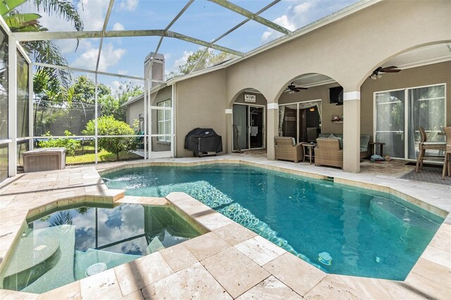 view of pool with a lanai, grilling area, a patio area, and ceiling fan