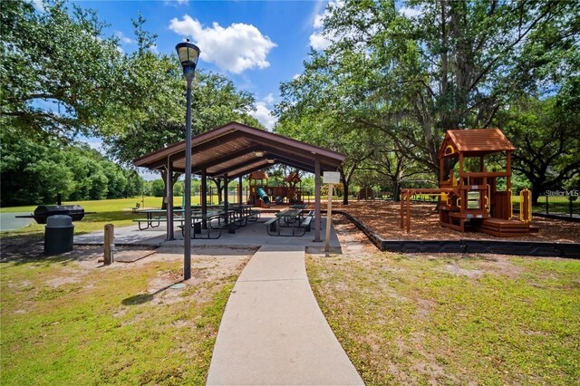 view of home's community featuring a lawn and a playground