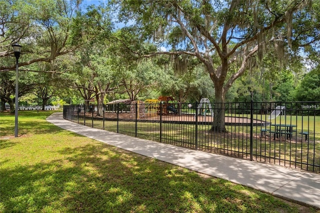 view of community featuring a playground and a lawn