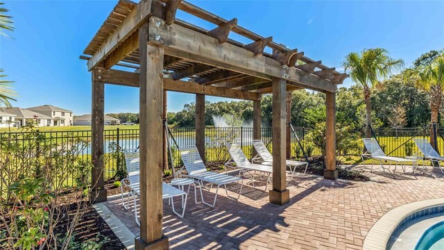 view of patio / terrace featuring a water view and a pergola