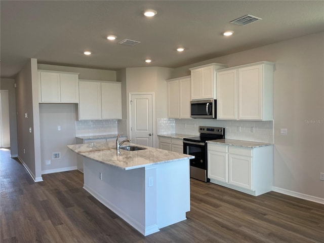 kitchen featuring appliances with stainless steel finishes, light stone counters, sink, white cabinetry, and a kitchen island with sink