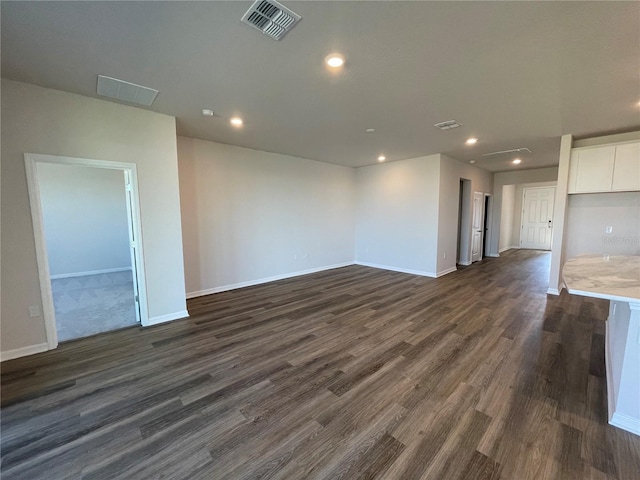 empty room with dark hardwood / wood-style flooring