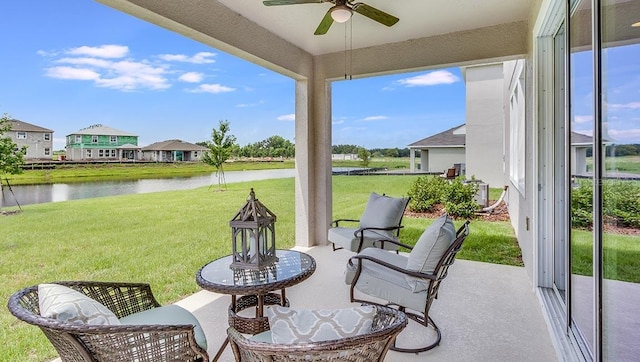 view of patio featuring a water view and ceiling fan