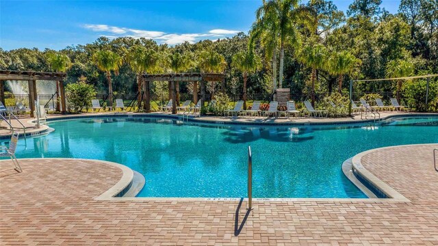 view of swimming pool with a pergola and a patio