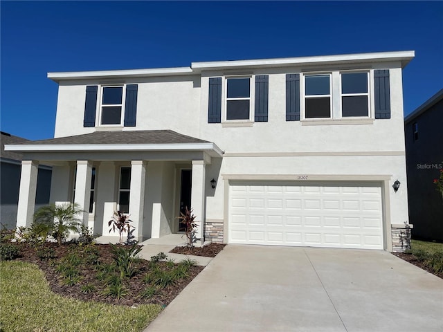 18207 Fattoria Ter, Lakewood Ranch, FL 34211 - view of front of home featuring stucco siding, a porch, driveway, an attached garage, and stone siding