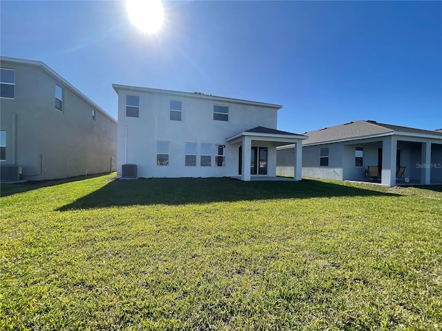 18207 Fattoria Ter, Lakewood Ranch, FL 34211 - back of house featuring a lawn and stucco siding