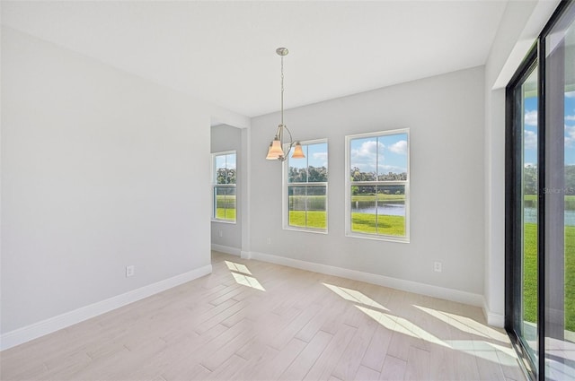 empty room featuring light hardwood / wood-style flooring and a water view