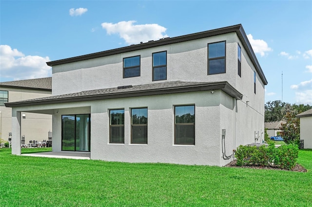 back of house featuring a yard and a patio