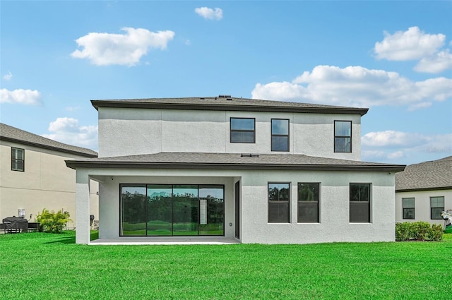 rear view of house featuring a lawn and a patio area