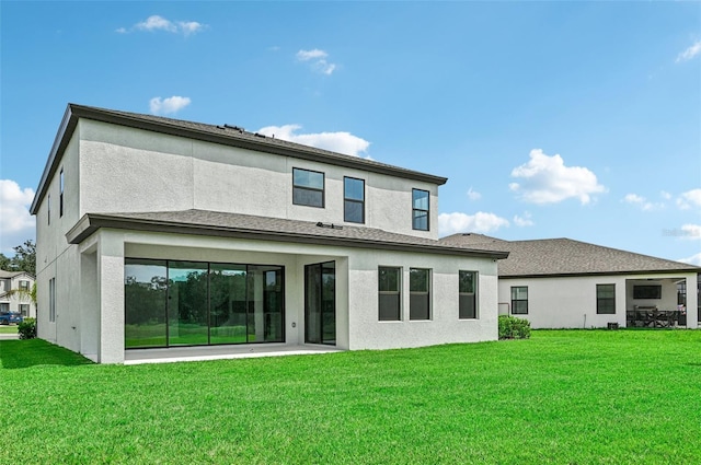 rear view of house featuring a yard